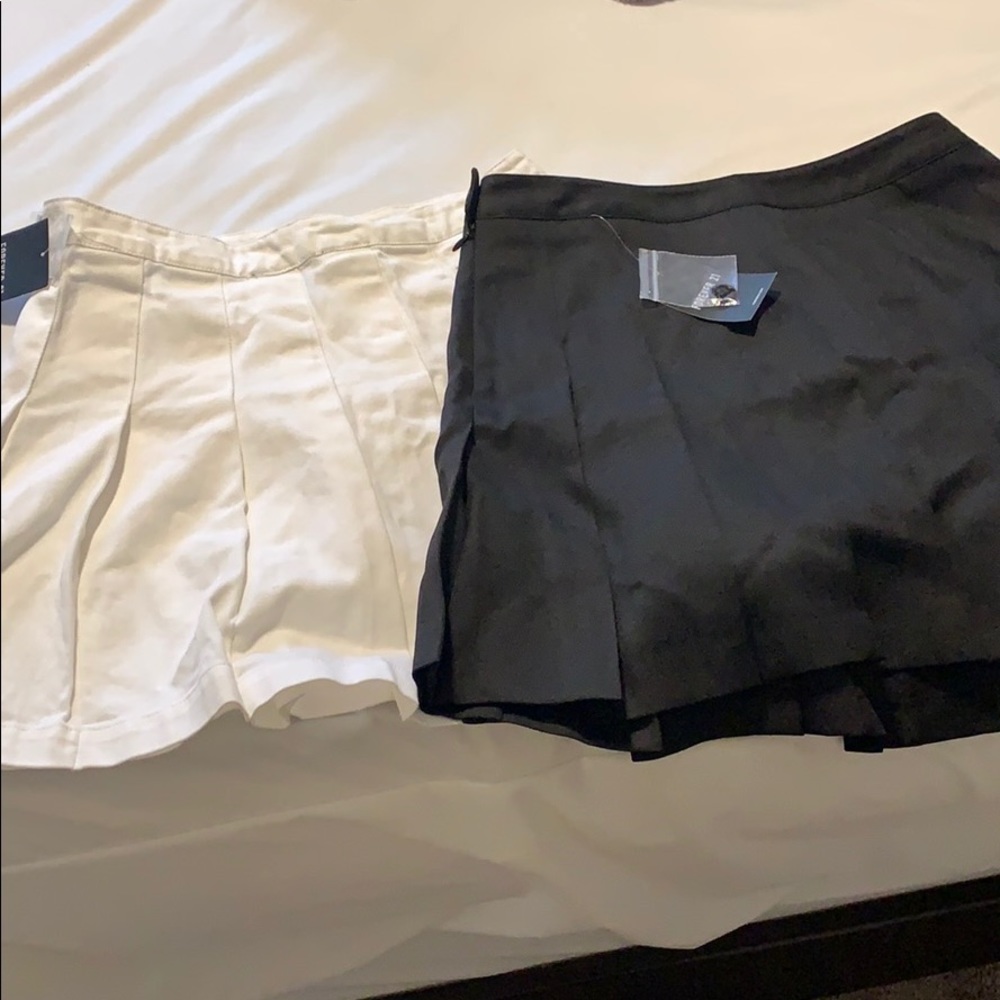 One black  pleaded skirt and one white one.